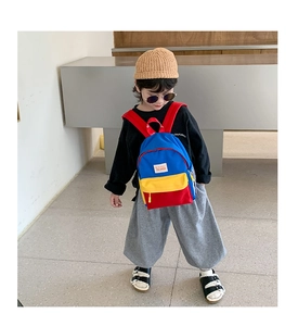 Detail of colorful kids canvas backpack with red yellow and blue color block design