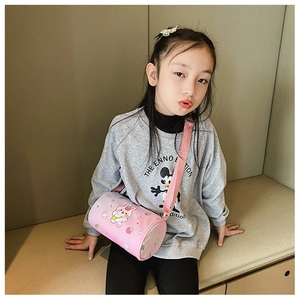Close-up of pink cylinder cross-body bag for girls with cute rabbit and strawberry prints