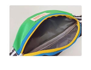 Detail view of children's color-block sling bag interior with lining and zipper pocket