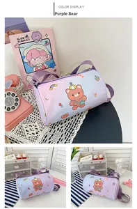 Detail view of purple cylinder bear bag with adjustable shoulder strap and Luck print