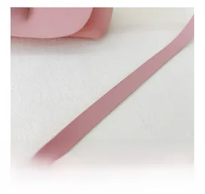 Detail shot of the pink PU leather shoulder strap with neat edge stitching