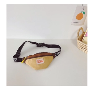 Detail of kids canvas chest bag in yellow and brown with adjustable lettered strap