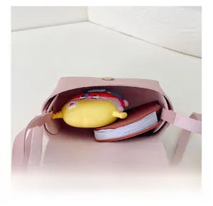 Detail view of pink girl's PU mini crossbody bag showing internal capacity and magnetic closure