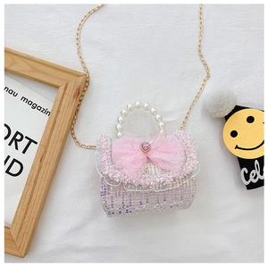Detailed shot of pink sequin girls handbag with pearl handle and lace bow detail