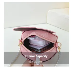 Internal capacity of pink patent leather peach crossbody bag with pearl chain strap