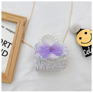 Detailed shot of purple sequin girls purse with pearl handle and bow heart detail