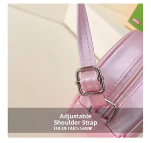 Detail shot of the adjustable shoulder strap with silver buckle on pink glitter girls bag