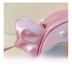Detail showing pink sequin fabric with pearl accents and iridescent shell embroidery
