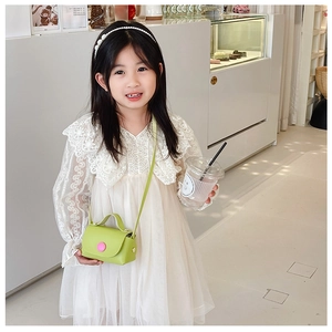 Detail of girls' bright green mini PU leather crossbody bag with pink round decoration