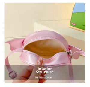 Internal structure detail of pink girl's wing bag with zipper and adjustable strap