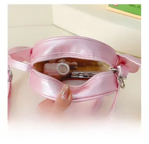 Close-up of pink pearlescent girls' bag interior showing storage space for small items
