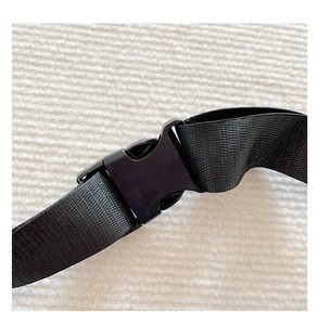 Close-up of adjustable black nylon strap and durable plastic buckle on a kids chest bag