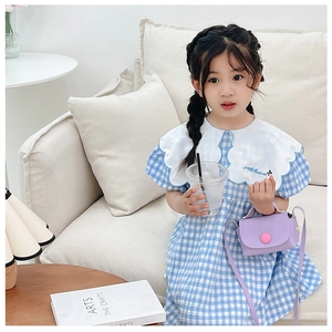 Detailed view of large sailor collar with embroidery on blue plaid girls' cotton dress