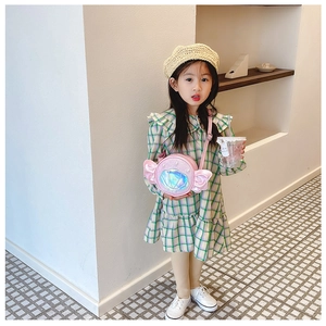 Detailed view of girls pink candy-shaped crossbody bag with iridescent shell decoration