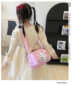 Detailed back view of a pink canvas cylinder bag with cartoon rabbit and strawberry prints