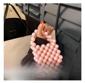 Detailed view of handmade pink beaded mini handbag with circular handle for girls