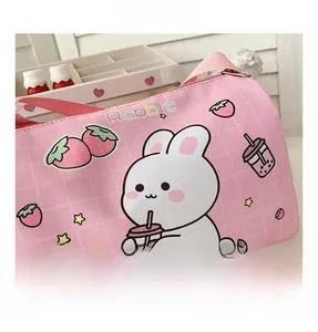 Detailed view of pink plaid cylinder bag with rabbit milk tea print and metal zipper
