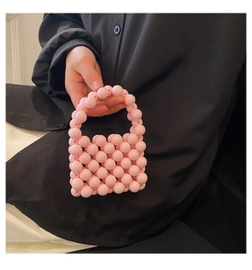 Detailed view of handmade pink beaded mini handbag with pearl handle for girls