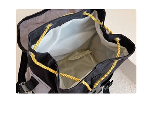 Detail of kids backpack interior with waterproof lining and yellow drawstring closure