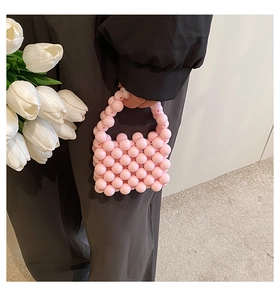 Detail of pink beaded mini handbag for girls with pearl-style round beads and top handle