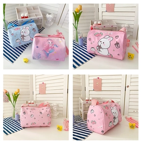 Detail view of pink and blue cylindrical rabbit canvas shoulder bags for girls