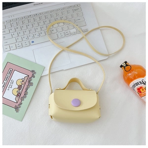 Detailed top view of a yellow mini PU leather crossbody bag with purple buckle and strap