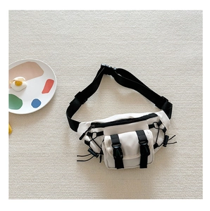Detail of trendy kids' canvas chest bag with tactical straps and multi-pocket zippers