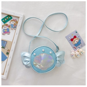 Macro shot of light blue shell crossbody bag with sequins and pearl details