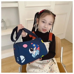 Detail of dark blue children's astronaut canvas barrel bag worn by a young girl