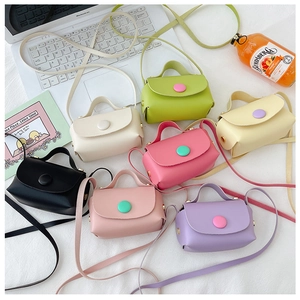 Flat lay of colorful PU leather mini saddle bags for girls in pastel macaron shades