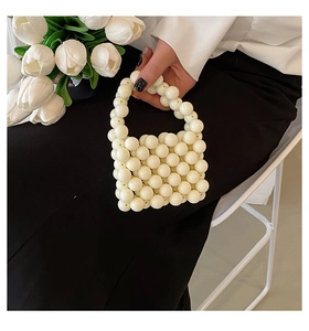 Close-up of elegant mini white faux pearl beaded handbag for girls with round beads