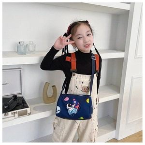 Detail of kids canvas crossbody bag featuring cute cartoon astronaut and space patterns