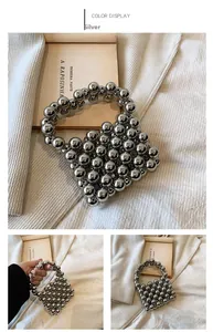 Detail of silver beaded handbag with metallic beads and matching round top handle