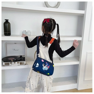 Detail of blue cylinder astronaut crossbody bag for kids with adjustable strap