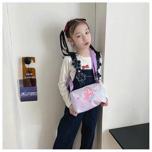 Detail of purple canvas toddler crossbody bag featuring a cartoon mermaid print pattern