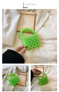 Detail of green handmade beaded mini handbag with pearl-style woven texture and handle