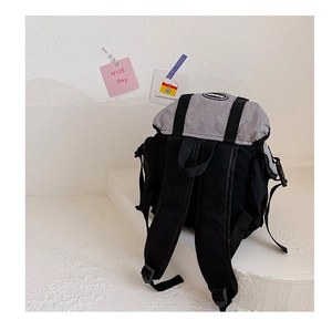 Detail view of the gray and black kids backpack with adjustable straps and logo