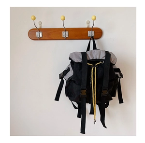 Detail showing durable canvas texture and yellow decorative drawstring on a kid's backpack