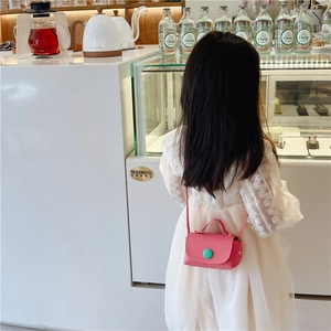 Pink PU leather mini crossbody bag for girls shown in a stylish lifestyle setting