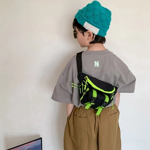 Trendy kids canvas chest bag in black and neon green with adjustable straps