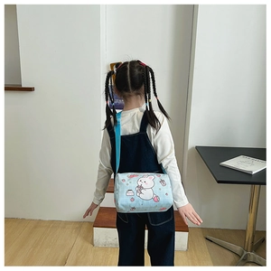 Rear view of child wearing a light blue bunny canvas bag with adjustable strap