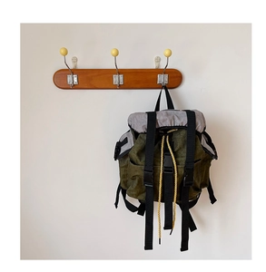 Detail of a kids olive green canvas backpack with drawstring closure and buckle straps