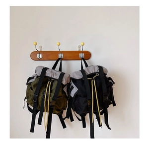 Detail of lightweight canvas backpack for boys featuring secure buckles and contrast ropes