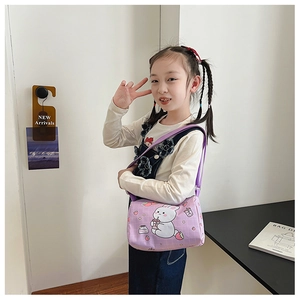 Detail of purple cylindrical canvas bag with cute cartoon rabbit print and strap