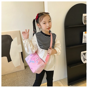 Pink cartoon mermaid crossbody bag for girls with adjustable strap shown on model