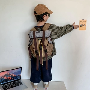 Kids vintage canvas backpack in brown and grey with adjustable straps and fashion label