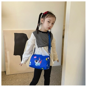 Close-up of blue children's canvas shoulder bag featuring space astronaut patterns