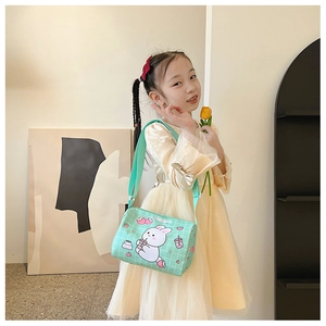 Detail of girl wearing mint green rabbit canvas cylinder bag with cute cartoon prints