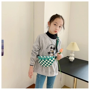 Gros plan d'un enfant portant un sac de poitrine en toile à damier vert et blanc