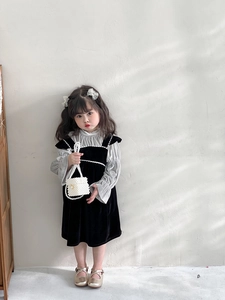 Detailed view of girls velvet dress suit with ruffle shirt and pearl handle bag